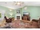 Bright and airy living room with a fireplace, hardwood floors, and plenty of seating for entertaining guests at 229 White Oak Farm Dr, Willow Springs, NC 27592