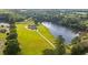 Stunning aerial view of lakeside estate with lush green lawn and private driveway at 2493 Nc-242, Benson, NC 27504