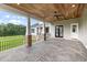 Rear porch featuring patterned concrete, wood ceiling, and views of the home's backyard and lake at 2493 Nc-242, Benson, NC 27504