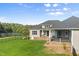 Home exterior with a rear patio, steps to the yard, and a view of the lake at 2493 Nc-242, Benson, NC 27504