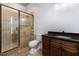 Bathroom with a granite vanity, toilet and a glass door shower with tiled walls at 2493 Nc-242, Benson, NC 27504