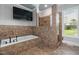 Bathroom featuring a tiled shower, soaking tub, and large window providing an elegant space to relax at 2493 Nc-242, Benson, NC 27504