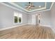 Bedroom featuring hardwood flooring, large windows, and a ceiling fan providing comfort and style at 2493 Nc-242, Benson, NC 27504