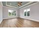 Bedroom features large windows, a ceiling fan, and hardwood floors, creating a comfortable and inviting space at 2493 Nc-242, Benson, NC 27504
