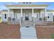 Charming front porch with stone details, white columns, and easy entry at 2493 Nc-242, Benson, NC 27504