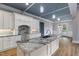 Bright kitchen showcases an island with granite countertops, white cabinetry, and a stunning blue ceiling at 2493 Nc-242, Benson, NC 27504