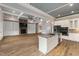 Open-concept living space features a stone fireplace, built-in shelving, and a kitchen island with granite countertops at 2493 Nc-242, Benson, NC 27504
