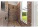 Walk-in shower with tiled walls, a shower head, and a window offers a spa-like experience at 2493 Nc-242, Benson, NC 27504