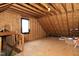 Unfinished attic space with wooden beam framing offers potential for storage or custom renovation at 25 Ruth Cir, Fuquay Varina, NC 27526