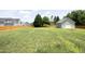 Large backyard with a wooden fence and a detached garage or workshop in the back of the property at 25 Ruth Cir, Fuquay Varina, NC 27526