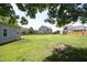 Expansive green backyard showing the deck on the house and a large grassy area surrounded by a wooden fence at 25 Ruth Cir, Fuquay Varina, NC 27526