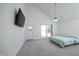 Bright bedroom with vaulted ceiling, ceiling fan, carpeted floor, and door to back at 25 Ruth Cir, Fuquay Varina, NC 27526