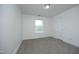 The bedroom has plush carpet, a light fixture, and a window inviting natural light at 25 Ruth Cir, Fuquay Varina, NC 27526