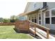 Deck area with wooden railing, ramp, and awning on the back of the house, leading to the grassy yard at 25 Ruth Cir, Fuquay Varina, NC 27526