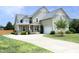 Two-story home with a well-manicured lawn, large driveway, and attached garage at 25 Ruth Cir, Fuquay Varina, NC 27526