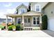 Inviting front porch with detailed trim, brick accents, and beautiful landscaping at 25 Ruth Cir, Fuquay Varina, NC 27526