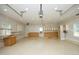 Spacious garage featuring ample cabinet and counter space, pegboard, and a pull-down heater unit at 25 Ruth Cir, Fuquay Varina, NC 27526