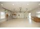 Interior view of large garage with ample space and a garage door, side entry door, and work bench at 25 Ruth Cir, Fuquay Varina, NC 27526