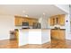Modern kitchen with custom wood cabinets, stainless steel appliances, and an island with countertop seating at 25 Ruth Cir, Fuquay Varina, NC 27526