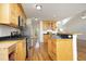 Bright kitchen features stainless appliances, wood cabinets, and hardwood floors at 25 Ruth Cir, Fuquay Varina, NC 27526