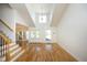 Spacious living room with hardwood floors, a staircase, and access to the dining area at 25 Ruth Cir, Fuquay Varina, NC 27526