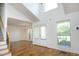 Bright living room featuring hardwood floors, large windows, and high vaulted ceilings at 25 Ruth Cir, Fuquay Varina, NC 27526