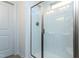 Modern walk-in shower with glass enclosure, sleek fixtures, and bright, clean design at 273 Johnson Ridge Way, Four Oaks, NC 27524