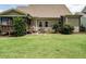 Lush backyard with a patio, grill, and screened porch offers ample space for outdoor living at 3021 Lawson Walk Way, Rolesville, NC 27571
