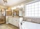The primary bathroom features tile floors, double sinks, a glass-enclosed shower, and a soaking tub at 3021 Lawson Walk Way, Rolesville, NC 27571