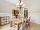 Bright dining room with wainscoting, a wooden table, and a modern chandelier at 3021 Lawson Walk Way, Rolesville, NC 27571