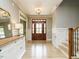 Elegant entryway featuring a hardwood floor, wainscoting, and a stylish light fixture at 3021 Lawson Walk Way, Rolesville, NC 27571