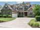 Charming two-story home with stone and shingle accents and a well-manicured lawn at 3021 Lawson Walk Way, Rolesville, NC 27571