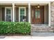 Inviting front porch with rocking chairs and a decorative flower bush at 3021 Lawson Walk Way, Rolesville, NC 27571