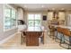 Bright kitchen features custom cabinets, granite countertops, a kitchen island, and an adjacent dining area at 3021 Lawson Walk Way, Rolesville, NC 27571