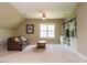Living room with a ceiling fan, leather sofa, coffee table, window, and built-in bookshelves at 3021 Lawson Walk Way, Rolesville, NC 27571