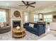 Open-concept living room features a fireplace and seamless transition into the modern kitchen and dining area at 3021 Lawson Walk Way, Rolesville, NC 27571