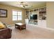 Living room with a ceiling fan, leather sofa, coffee table, window, and built-in bookshelves at 3021 Lawson Walk Way, Rolesville, NC 27571
