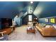 Cozy living room with a ceiling fan, leather sofa, TV, accent seating, and blue walls at 3021 Lawson Walk Way, Rolesville, NC 27571