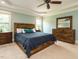 Spacious main bedroom with a wooden bed frame and light-filled windows, perfect for rest and relaxation at 3021 Lawson Walk Way, Rolesville, NC 27571