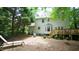 Spacious backyard featuring a wood deck, lush greenery, and a tranquil outdoor seating area at 304 Ramblewood Dr, Raleigh, NC 27609