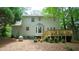 Exterior rear view with wood deck, bay window, patio space, and mature trees at 304 Ramblewood Dr, Raleigh, NC 27609