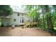 Rear exterior of house with deck, bay window, mature trees, and private setting at 304 Ramblewood Dr, Raleigh, NC 27609