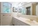 Bathroom with double sink vanity, ample light, neutral color palette and framed artwork at 304 Ramblewood Dr, Raleigh, NC 27609