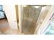 Tiled shower adjacent to a bathroom door and window for ample natural light and ventilation at 304 Ramblewood Dr, Raleigh, NC 27609