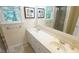 Bathroom with double sink vanity, ample light, neutral color palette and framed artwork at 304 Ramblewood Dr, Raleigh, NC 27609