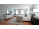 Relaxing bedroom featuring light blue walls, hardwood floors and stylish decor at 304 Ramblewood Dr, Raleigh, NC 27609