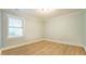Clean bedroom with light blue walls, natural light and wood flooring at 304 Ramblewood Dr, Raleigh, NC 27609