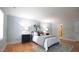 Stylish bedroom with hardwood floors, light blue walls, neutral decor and a patterned rug at 304 Ramblewood Dr, Raleigh, NC 27609