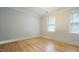 Clean bedroom with light blue walls, natural light and wood flooring at 304 Ramblewood Dr, Raleigh, NC 27609