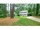 Two story home with black shutters on a lush lot, with driveway and guest house at 304 Ramblewood Dr, Raleigh, NC 27609